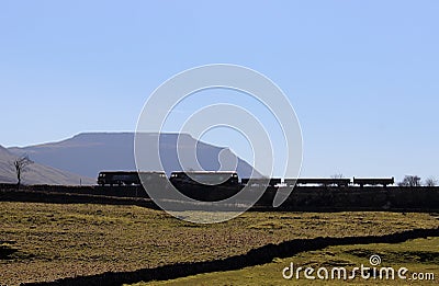 Silhouette of diesel locomotives with mountain Editorial Stock Photo