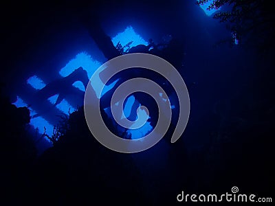 Silhouette of diver penetrating wreck Stock Photo