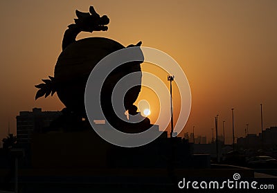 Silhouette of a dragon sculpture during golden hour Editorial Stock Photo