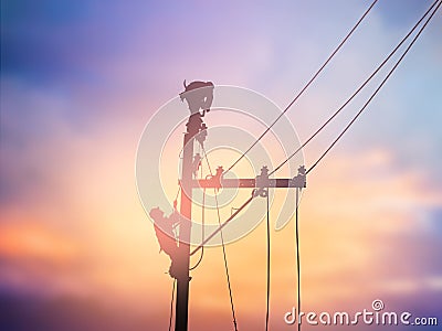 Silhouette electrical workers are installing high voltage system Stock Photo