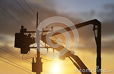 Silhouette electrician works on bucket Stock Photo