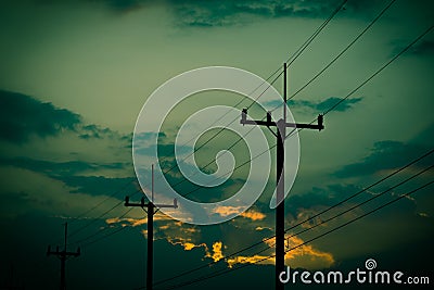 Silhouette electricity post with beautiful sunset background. Stock Photo