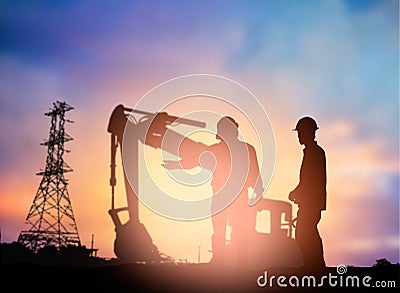 Silhouette engineer working in a building site over Blurred co Stock Photo