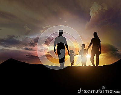 Silhouette of family facing the sunset Stock Photo