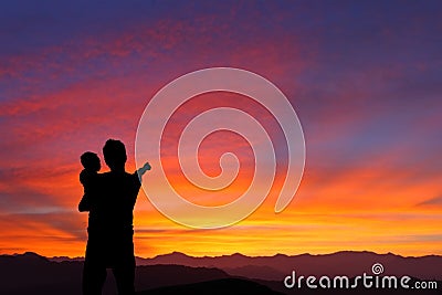 Silhouette of Father and child watching sunrise Stock Photo