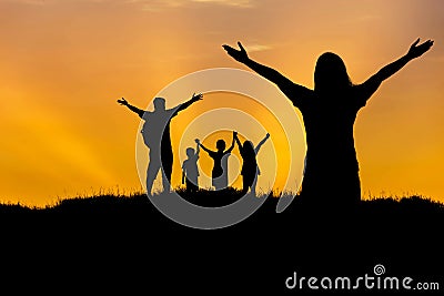 Silhouette father and mother and children standing raised hands up on sunset Stock Photo