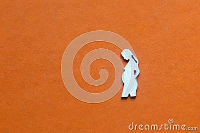 Silhouette of a figure of a pregnant woman on an orange Stock Photo