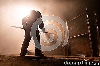 Silhouette firefighter escape from burining building Stock Photo