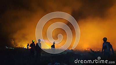 silhouette of a firefighter at the location of a forest fire Stock Photo