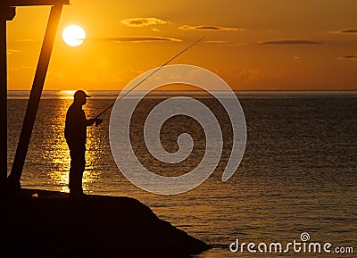 Silhouette of a fisherman Stock Photo