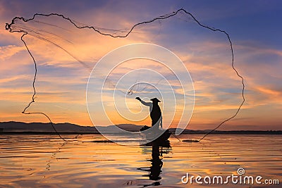 Silhouette fisherman on fishing boat setting net with sunrise Stock Photo