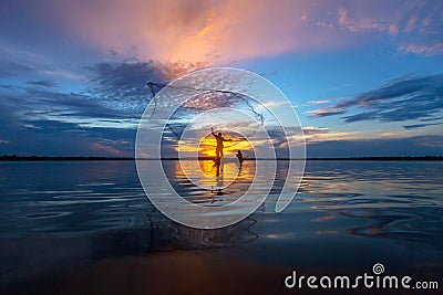Silhouette fisherman with net at the lake Stock Photo