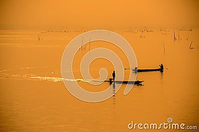 Silhouette fishermen on boat driving to fish Stock Photo