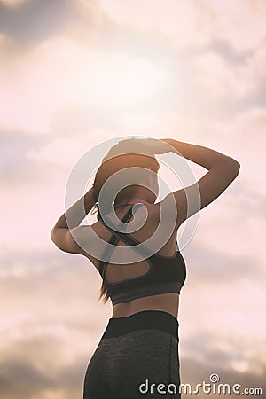 Silhouette fitness woman exercising at sunset time Stock Photo