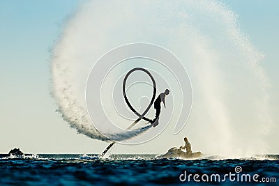 Silhouette of a fly board rider Stock Photo