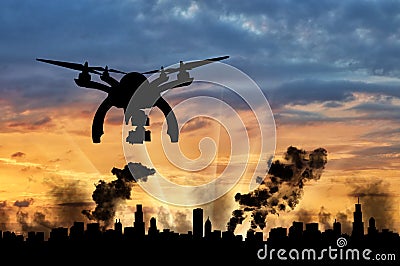 Silhouette flying reconnaissance drone over the city in smoke Stock Photo