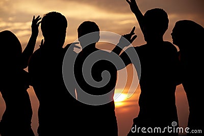 Silhouette Of Friends Having Beach Party Stock Photo