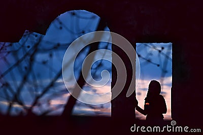 Silhouette of a girl with a candle Stock Photo