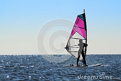 Silhouette of a girl windsurfer Stock Photo