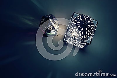 Silhouette of glowing Moroccan ornamental lanterns at night with decorative shadows. Greeting card, invitation for Stock Photo