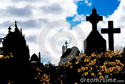 Silhouette of graveyard, the image shows many cross tombstone and field of yellow daisy flower with dramatic cloudy sky. Stock Photo