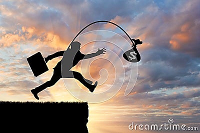 Silhouette of a greedy man running by looking at money, not noticing the abyss Stock Photo