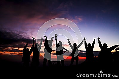 Silhouette of group of friends standing in sunset Stock Photo