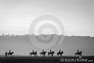 Silhouette of a group of horse riders at Bromo Stock Photo