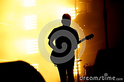 Silhouette of guitar player, guitarist perform on concert stage. Editorial Stock Photo