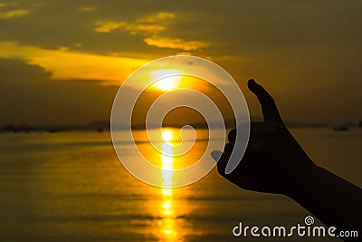 Silhouette of hand to pinky promise, pinky swear in front of the sun during sunset time. Love and valentine concept Stock Photo