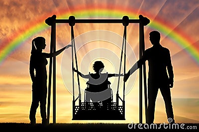 Silhouette of a happy child is a disabled person in a wheelchair on an adaptive swing Stock Photo