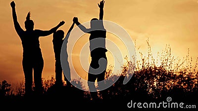 Silhouette, happy children with mother and father, family at sunset Stock Photo