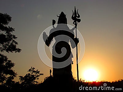 Silhouette of Hindu god Shiva at sunset Stock Photo