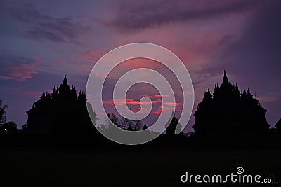 Silhouette of Hindu temple buildings during sunset with purple and red colours Stock Photo
