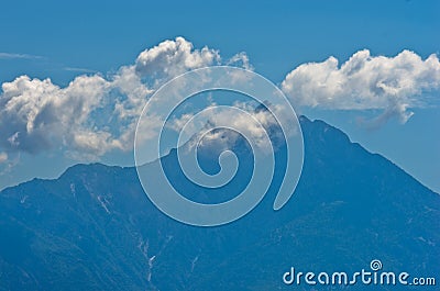 Silhouette of the holy mountains Athos and a small cloud above the mountain top, Chalkidiki Stock Photo