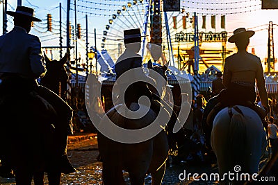 Silhouette of Horse riders at sunset. Seville`s April Fair. Editorial Stock Photo