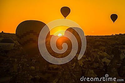 Silhouette of hot air balloons flying over the valley at Cappadocia, Anatolia, Turkey. Volcanic mountains in Goreme Editorial Stock Photo