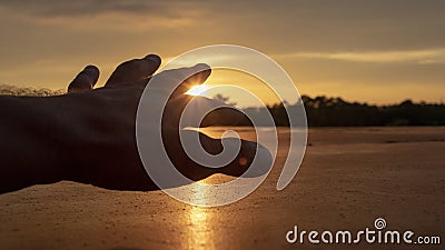 A silhouette of a human hand reaching out Stock Photo