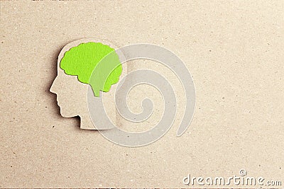 Silhouette human head with green brain on brown paper background Stock Photo