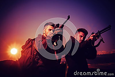 Silhouette of the hunter. Rifle Hunter Silhouetted in Beautiful Sunset. Hunting in Russia. Hunting is the practice of Stock Photo