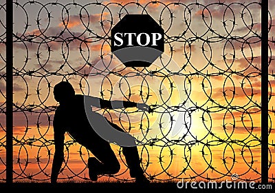 Silhouette of illegally crossing the border refugee Stock Photo