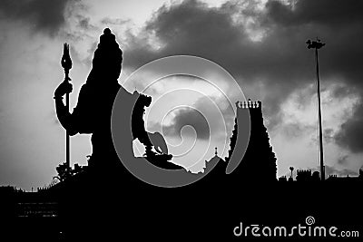 the silhouette image of hindu god lord shiva statue with white sky Stock Photo