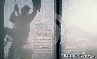 Silhouette images of man cleaning the window office building Stock Photo