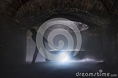 Silhouette of iron worker stoking a furnace in the Blaenavon Iron Works, Wales Stock Photo