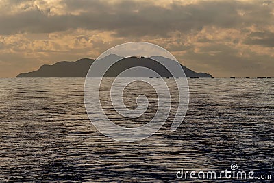 The silhouette of the Island of Gorgona, Italy, in the sunset light Stock Photo