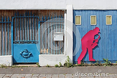The silhouette of a jazzman decorates the gate of a garage (France) Stock Photo