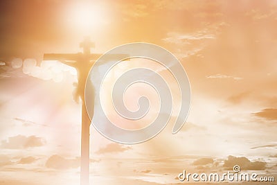 Silhouette Jesus Christ crucifixion on cross over sunset light background, prayer and praise religion concept Stock Photo