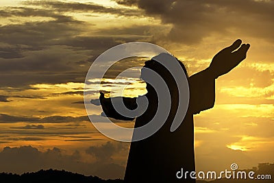 Silhouette of Jesus christ standing with raised arms Stock Photo