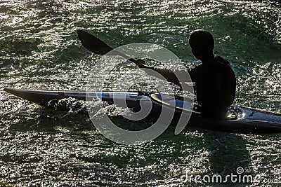 Silhouette of Kayaker in Strong Light on the Turbulent Soca Stock Photo