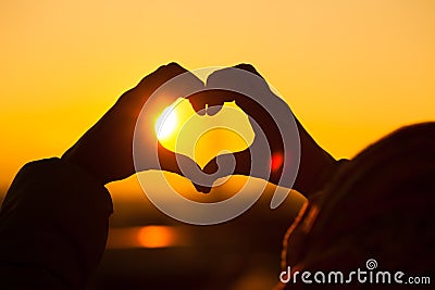 Silhouette of a kid making heart with hands Stock Photo